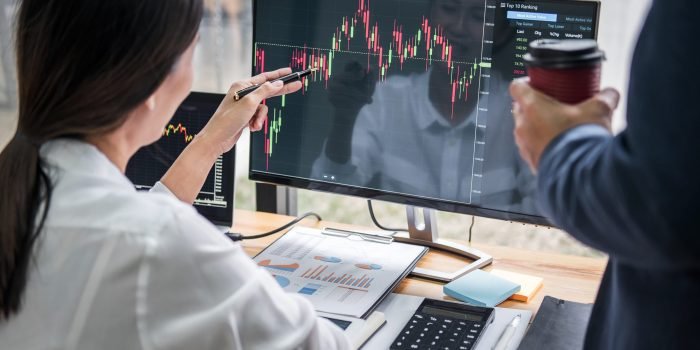 Business team investment working with computer, planning and analyzing graph stock market trading with stock chart data, business financial investment and technology concept.